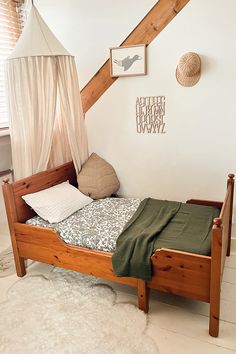 a bed with a canopy and pillows on top of it