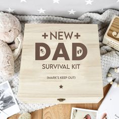 a new dad survival kit with photos and toys on the floor, including a teddy bear