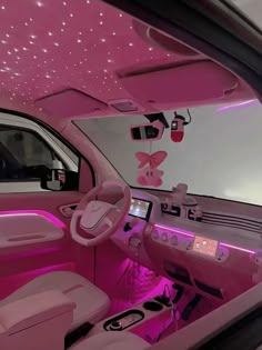 the interior of a car with pink lighting