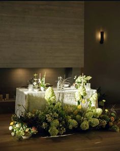 the table is set with flowers and candles