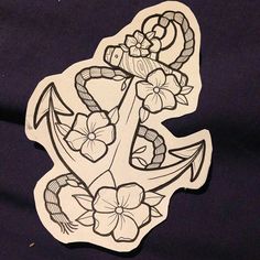 an anchor with flowers on it is shown in black and white paper cutouts