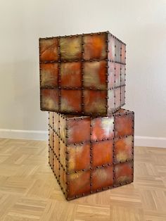 two cubes are stacked on top of each other in the middle of a room