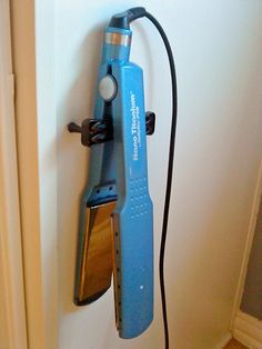 an electric toothbrush hooked up to a wall mounted hair dryer on the side of a door