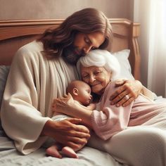 a woman holding a baby while laying on top of a bed