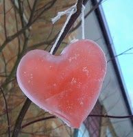 a heart shaped lollipop hanging from a tree