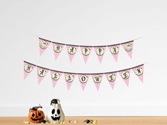 two halloween buntings and decorations on a table