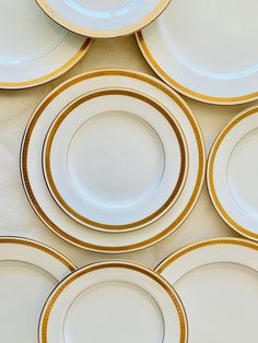 white and gold plates stacked on top of each other