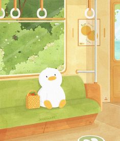 a white teddy bear sitting on top of a green couch in front of a window