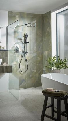 a bathroom with a bathtub, sink and shower head in the middle of it