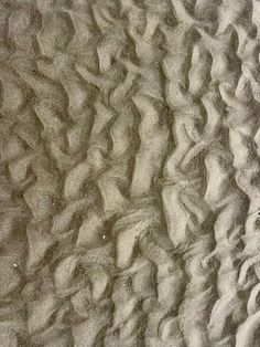 an image of sand patterns on the beach