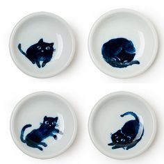 four plates with black cats painted on them