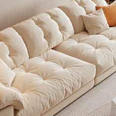 a white couch with several pillows on it