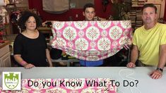 three people standing behind a table covered in pink and white fabric with the words do you know what to do?