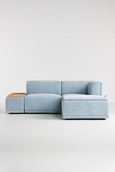 a blue couch sitting on top of a white floor