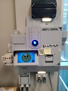 a machine with a blue light on it's face and some wires attached to it