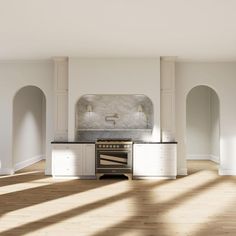 an empty kitchen with white cabinets and marble counter tops