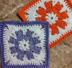 two square crocheted coasters with flowers on them sitting next to each other