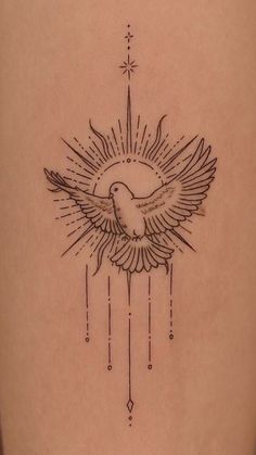 a tattoo on the back of a woman's leg with a bird flying over it