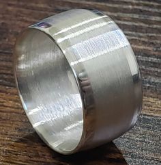 a silver ring sitting on top of a wooden table