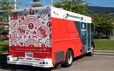 a red and white food truck parked in a parking lot