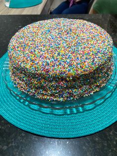 a cake with sprinkles sitting on top of a blue plate