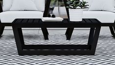 a coffee table sitting on top of a black and white rug