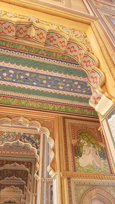 an intricately painted wall and ceiling in a building