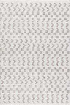 a white and gray rug with an arrow pattern on the bottom, it is made out of