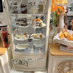 a display case filled with cakes and pastries