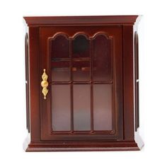 a wooden cabinet with glass doors and gold handles