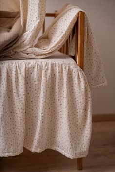 a bed with a white bedspread on top of it and a wooden headboard