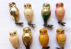 there are many different colored owl figurines on the table