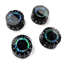 four black and iridescent knobs with numbers on them