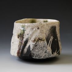 a white and black ceramic bowl sitting on top of a table