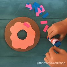 someone is making a doughnut out of construction paper