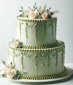 a three tiered cake decorated with flowers and leaves