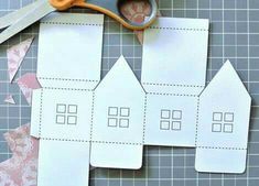 cut out paper houses with scissors on top