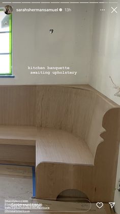 a wooden bench sitting next to a window in a room