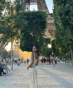 a woman standing in front of the eiffel tower