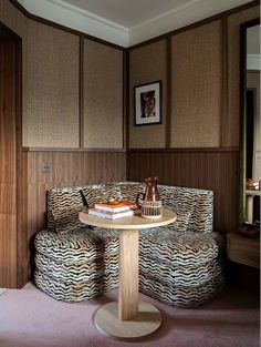 a living room with zebra print furniture and wood paneling