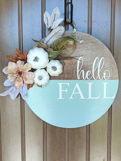 a sign that says hello fall hanging on a door