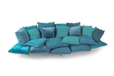 a blue couch with many pillows on it