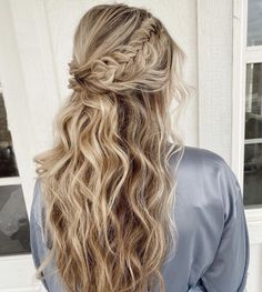 a woman with long blonde hair in a half - up braid