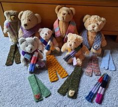 a group of teddy bears sitting next to each other on the floor in front of a dresser