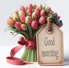 a bouquet of tulips in a vase next to a tag with the words good morning