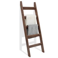 a wooden ladder with two towels on it