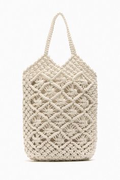 a crocheted white bag on a white background