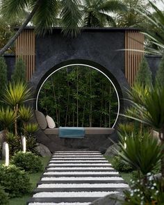 an outdoor garden with stone steps leading up to a bench and circular mirror on the wall