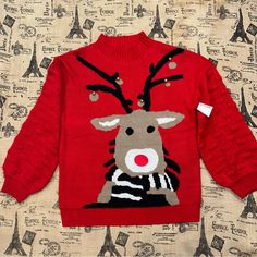 a red sweater with a reindeer on it