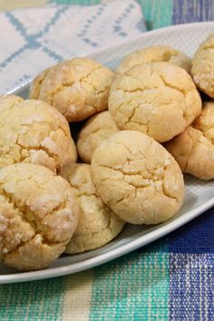 a white plate filled with cookies on top of a blue and green table cloths